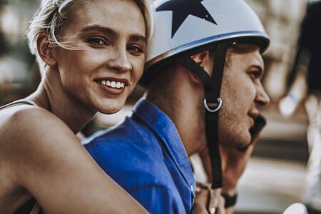 Man in helmet and smiling young lady behind him