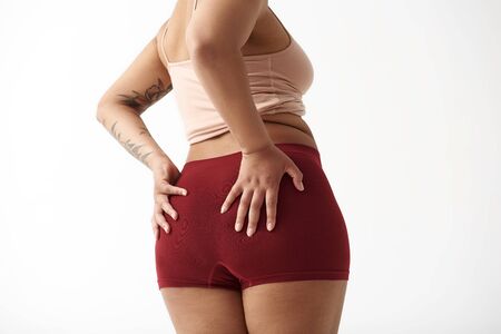 Afro American woman keeping hands on buttocks