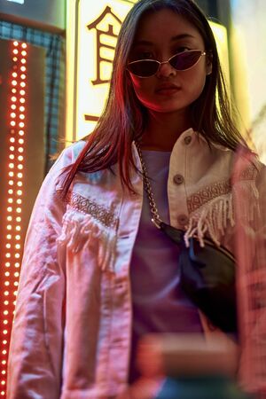 Stylish asian lady staying near japanese cafe