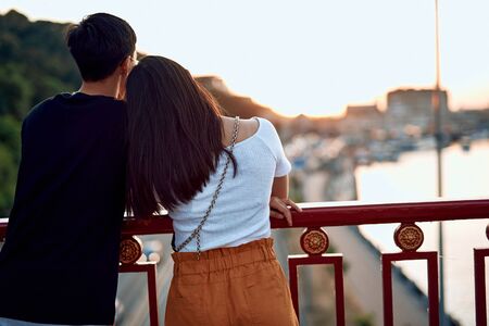 Beloved young couple dating on walking bridgeの写真素材