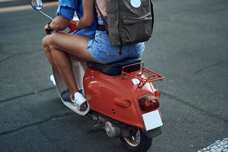 Legs of man and woman riding motorbike in the streetの写真素材