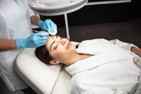 Cosmetologist with sponge is using blackhead removerの写真素材