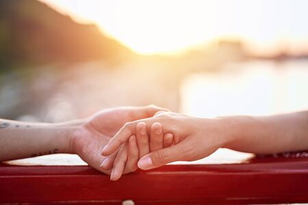 Close up holding hands of beloved cople