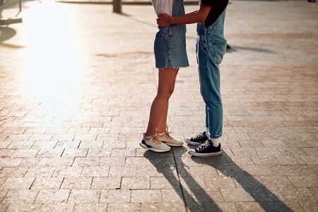 Happy beloved couple staying on street togetherの写真素材