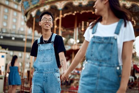 Happy asian couple walking together around cityの写真素材
