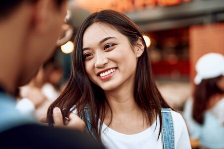 Young guy holding hair lock of his beloved ladyの写真素材