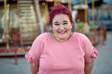 Young woman standing in city amusement parkの写真素材