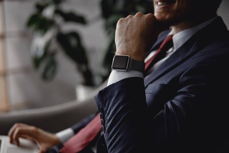 Close up of smart watch on the wrist of businessmanの写真素材