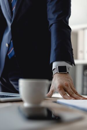 Selective focus of the hand on the table in officeの写真素材