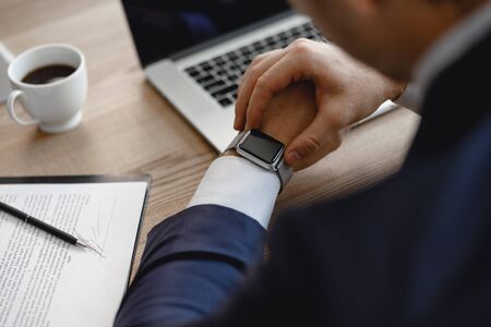 Close up of hand touching smart watch on the wristの写真素材