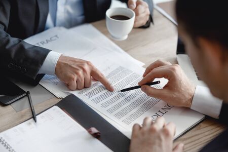 Two men pointing to the paragraph in contractの写真素材