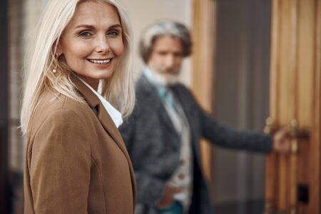 Joyful mature woman smiling outdoors stock photoの写真素材