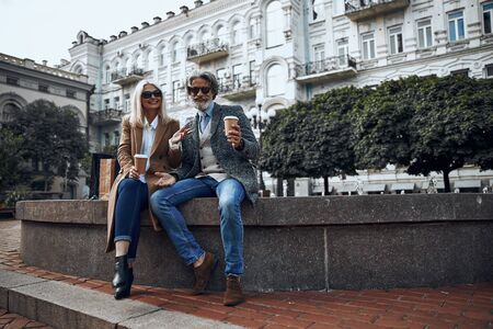 Happy man and woman on the fountain stock photoの写真素材