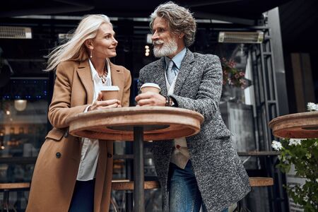 Smiling couple at the cafe high table stock photoの写真素材