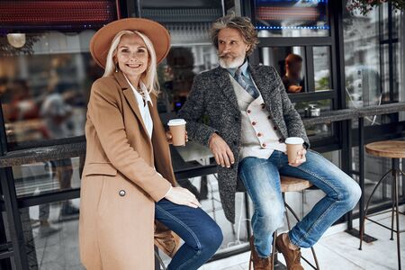 Gladsome couple in the street cafe stock photoの写真素材