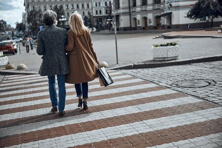 Romantic couple crossing the street stock photoの写真素材