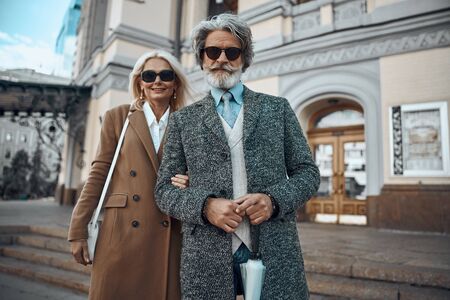 Smiling adult couple near the building stock photoの写真素材