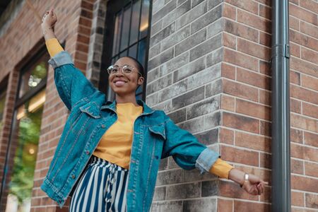 Young african american woman is walking outdoorsの写真素材