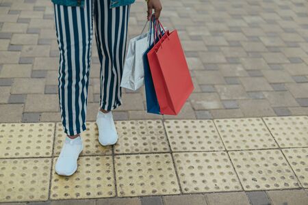 Young afro-american female is holding shopping bagの写真素材