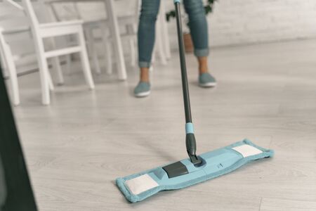Housewife doing cleaning with mop stock photo