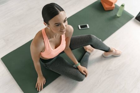 Cheerful female listening to music during workout stock photo