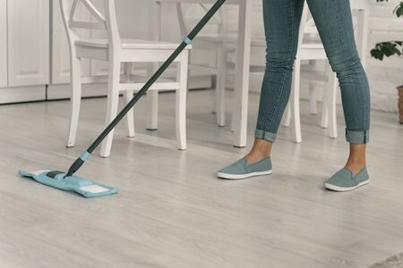 Woman tiding up floor with broom stock photo