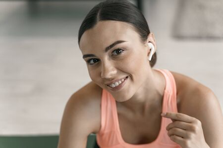 Happy woman with headphones at home stock photoの写真素材