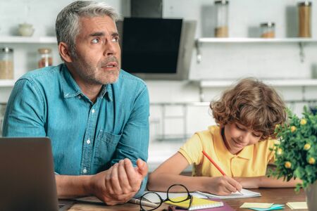 Father making school homework together with little kidの写真素材