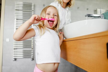Mom and daughter having fun in the bathroomの写真素材