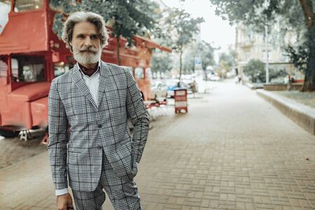 Stylish senior man standing on the street