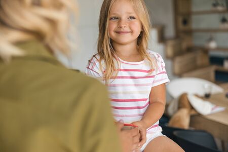 Gladsome girl looking away and smiling stock photoの写真素材