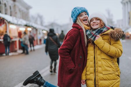 Positive delighted girls looking straight at cameraの写真素材