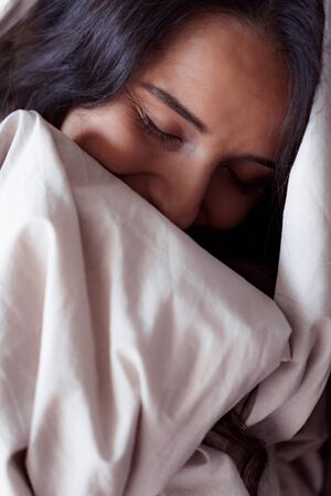 Young woman being sleepy after waking upの写真素材