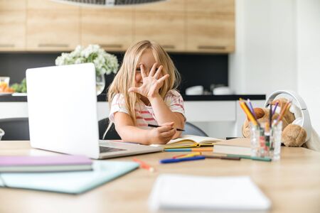Cute girl putting hand in front of her face stock photoの写真素材