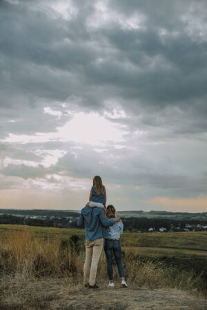 Happy family standing on top of a hillの写真素材