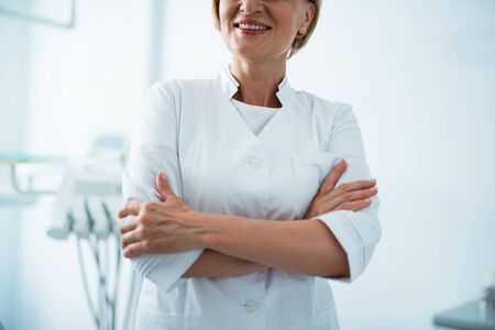Smiling female woman is posing at cameraの写真素材