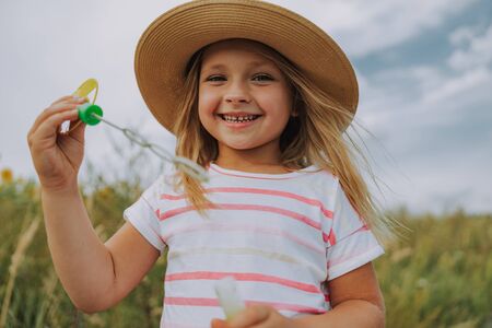 Happy beautiful child posing for camera outdoorsの写真素材