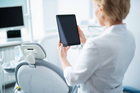 Female doctor is using digital tablet in clinicの写真素材
