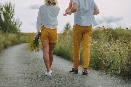 Calm young parents walking on the road outdoorsの写真素材