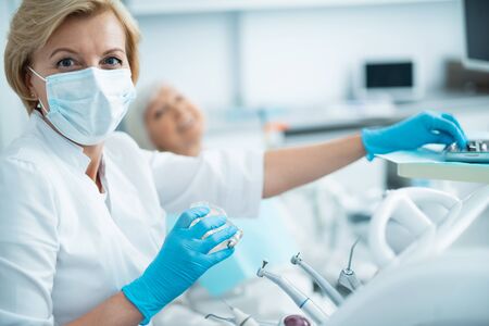 Doctor in sterile gloves posing at cameraの写真素材