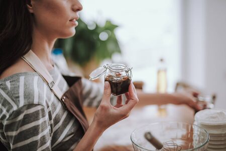 Young woman is cooking dessert at home