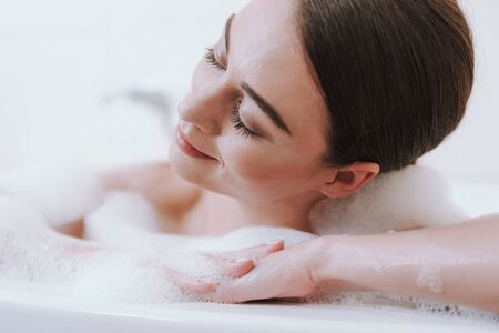 Close up of a delighted woman taking bath