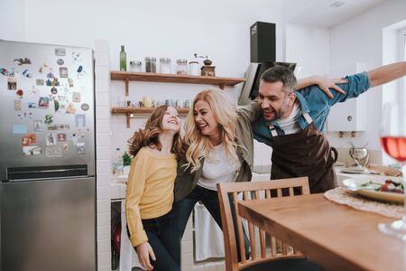 Happy family enjoying being together and having fun at homeの写真素材