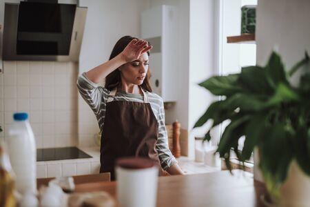 Housewife is tired of cooking at homeの写真素材