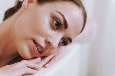 Portrait of a nice beautiful woman resting in the bathroomの写真素材