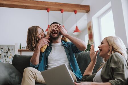 Cheerful daughter playing guess who game with her dadの写真素材