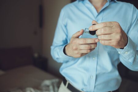 Man going to put on his perfume