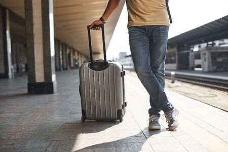 Low angle of a man carrying his luggageの写真素材