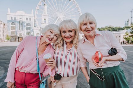 Three older women are spending time on squareの写真素材