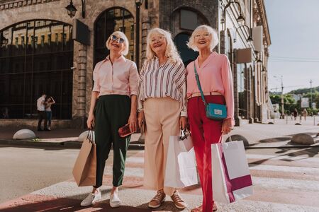 Nice grandmothers are standing on street togetherの写真素材